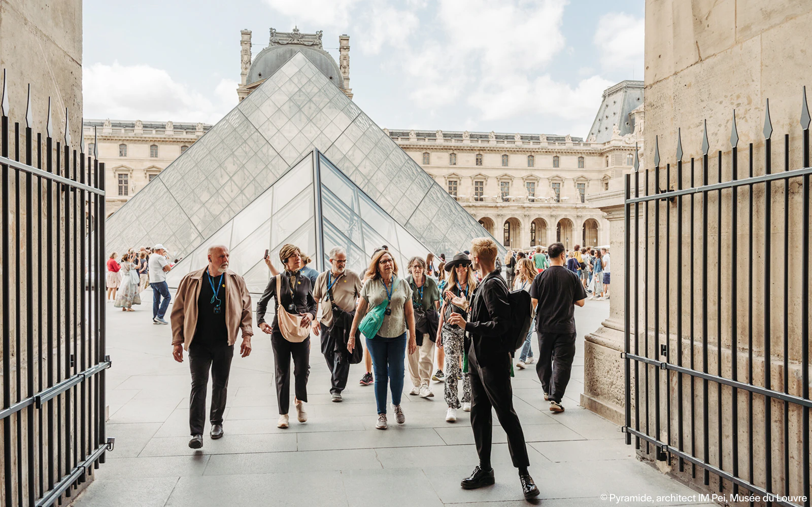 Aerial view of the Louvre Pyramid and surrounding courtyard in Paris.