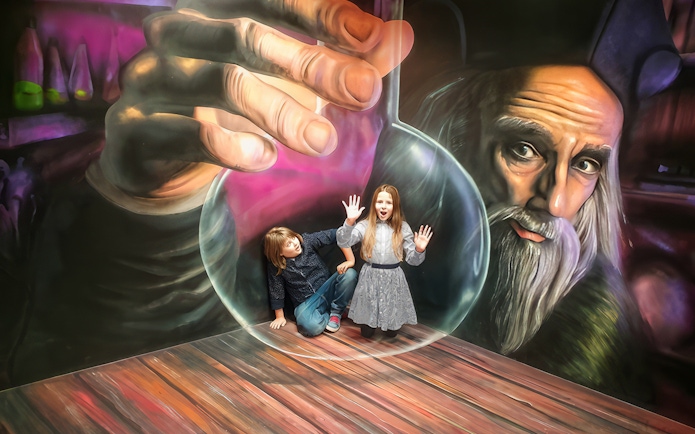Children interacting with optical illusion at Museum of Fantastic Illusions.