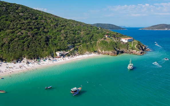 Aerial view of Pontal do Atalaia beaches with boats in Arraial do Cabo, Brazil.