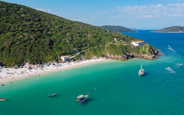 Aerial view of Pontal do Atalaia beaches with boats in Arraial do Cabo, Brazil.