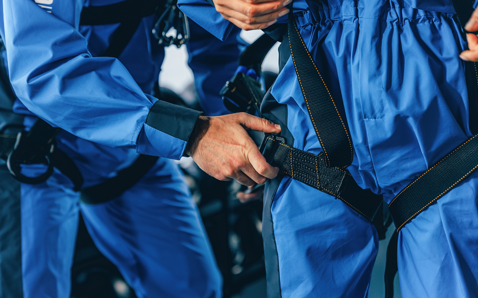 Climbers securing harnesses for City Climb Experience.