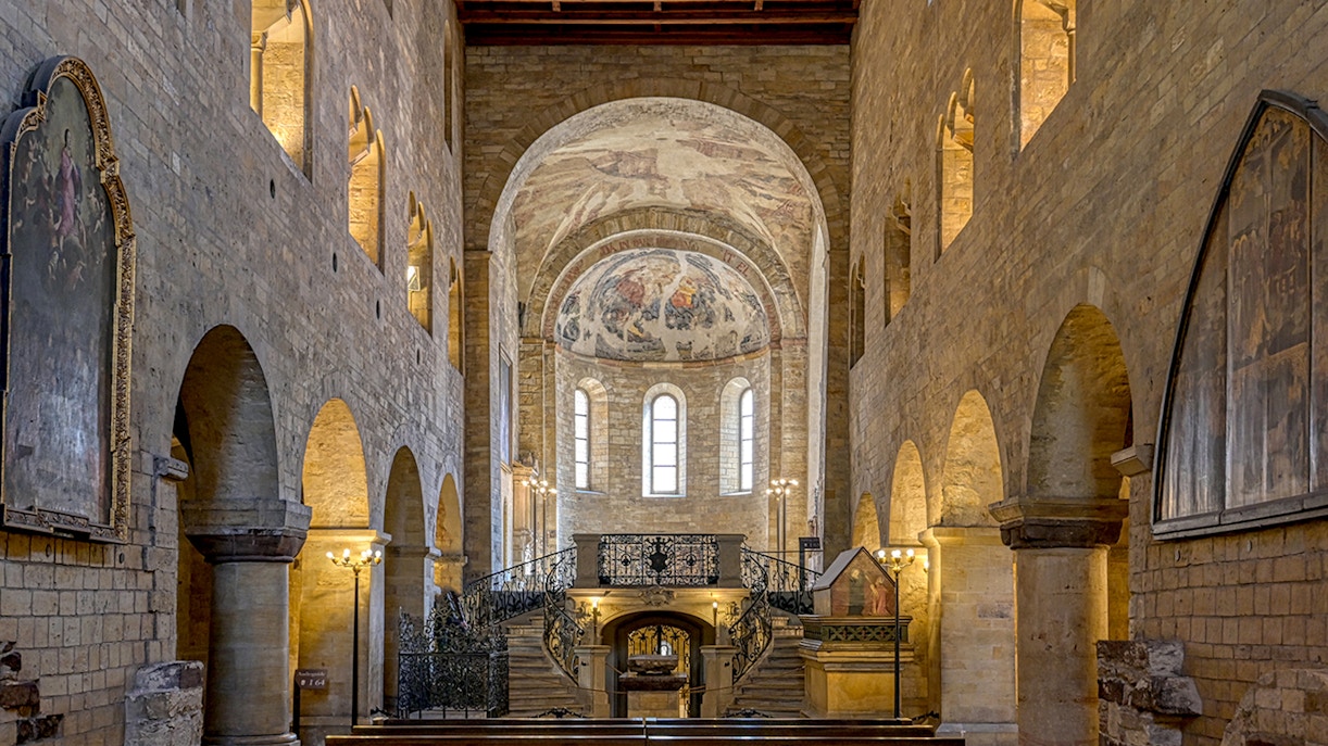 Interior of St. George's Basilica, Prague Castle, with arched ceilings and frescoes.
