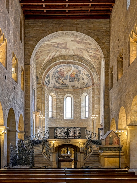 Interior of St. George's Basilica, Prague Castle, with arched ceilings and frescoes.
