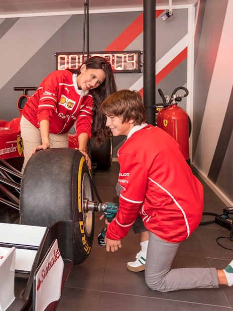 Visitors changing a tire on a Formula 1 car at Ferrari Land.