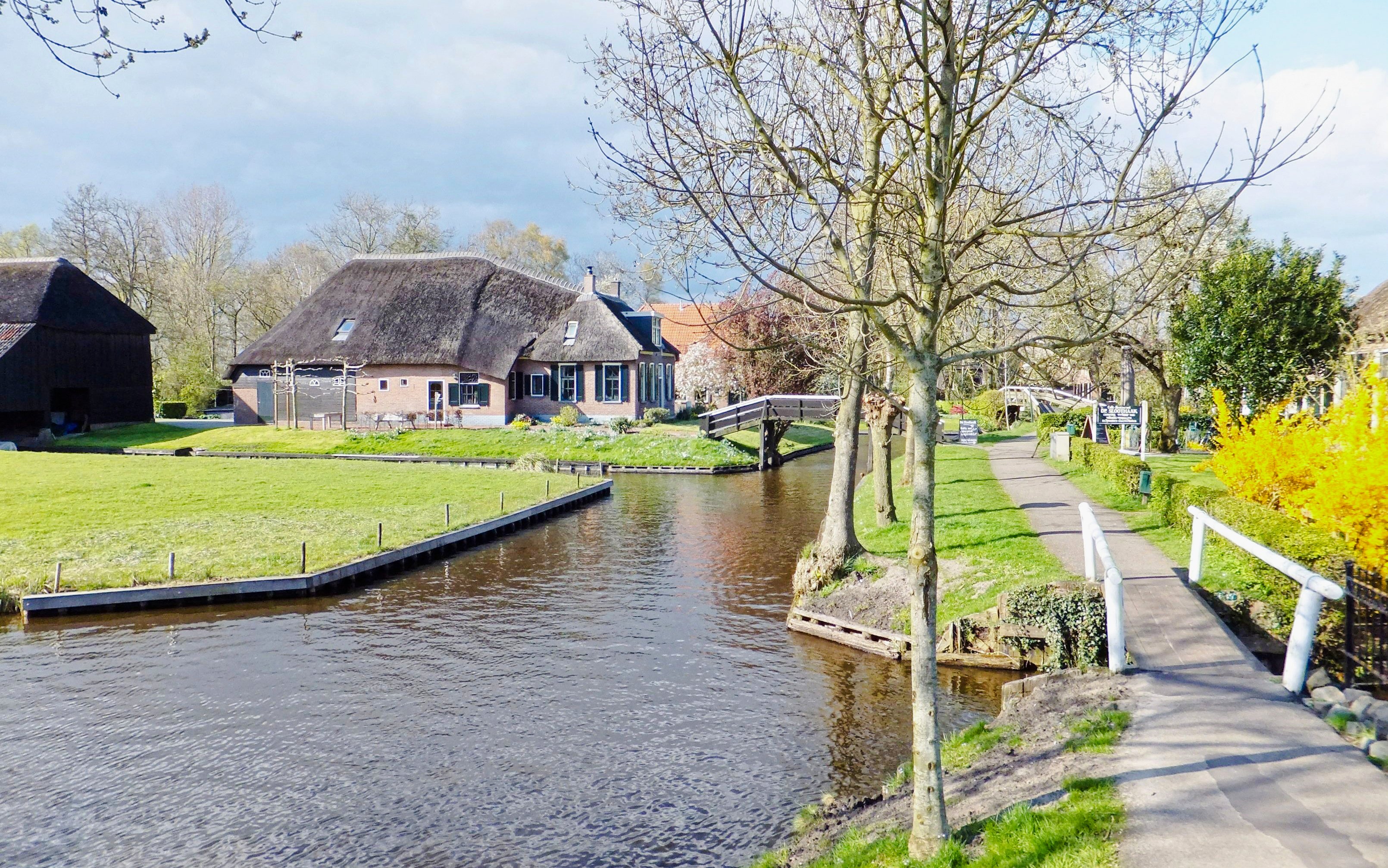 Canal and thatched-roof houses in Giethoorn, Amsterdam during winter.