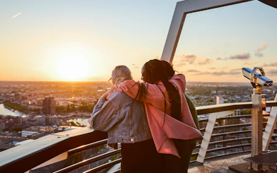 Guests enjoying sunset views from the Euromast viewing area in Rotterdam.