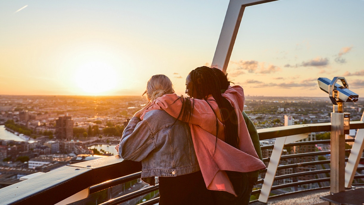 Guests enjoying sunset views from the Euromast viewing area in Rotterdam.