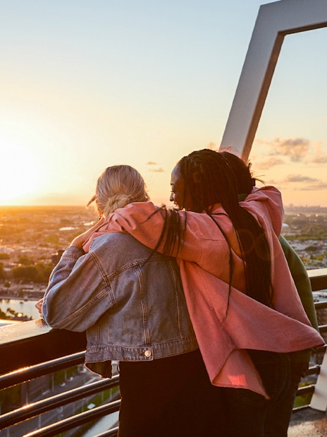 Guests enjoying sunset views from the Euromast viewing area in Rotterdam.