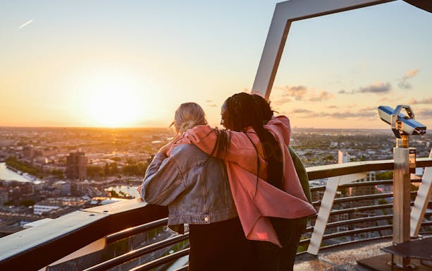 Guests enjoying sunset views from the Euromast viewing area in Rotterdam.