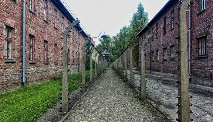 Stutthof Concentration Camp entrance gate with barbed wire fence in Sztutowo, Poland.