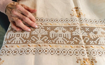 Hand touching intricate lacework at Poble Espanyol, Barcelona.