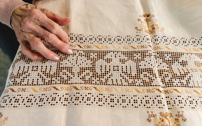 Hand touching intricate lacework at Poble Espanyol, Barcelona.