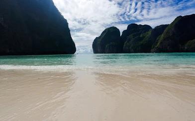 Sunrise view of Maya Bay's clear waters and limestone cliffs, Krabi.