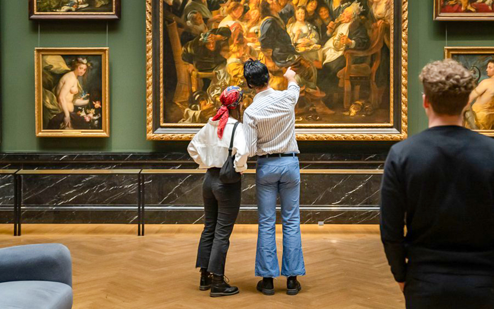 Guests admiring paintings inside Kunsthistorisches Museum Vienna.