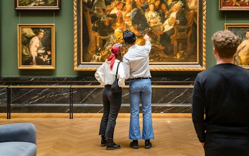 Guests admiring paintings inside Kunsthistorisches Museum Vienna.