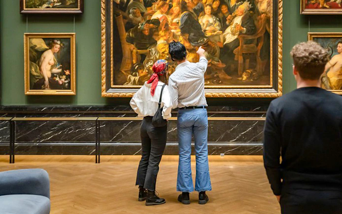Guests admiring paintings inside Kunsthistorisches Museum Vienna.