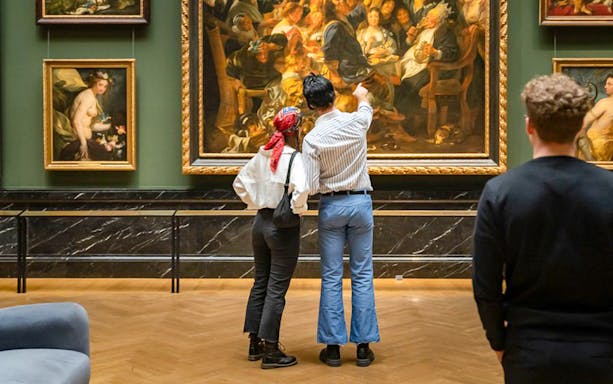 Guests admiring paintings inside Kunsthistorisches Museum Vienna.