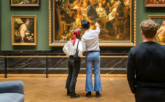 Guests admiring paintings inside Kunsthistorisches Museum Vienna.