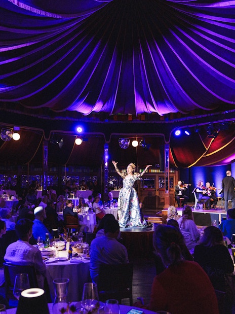Strauss concert at Prater Vienna with audience dining under a tented ceiling.