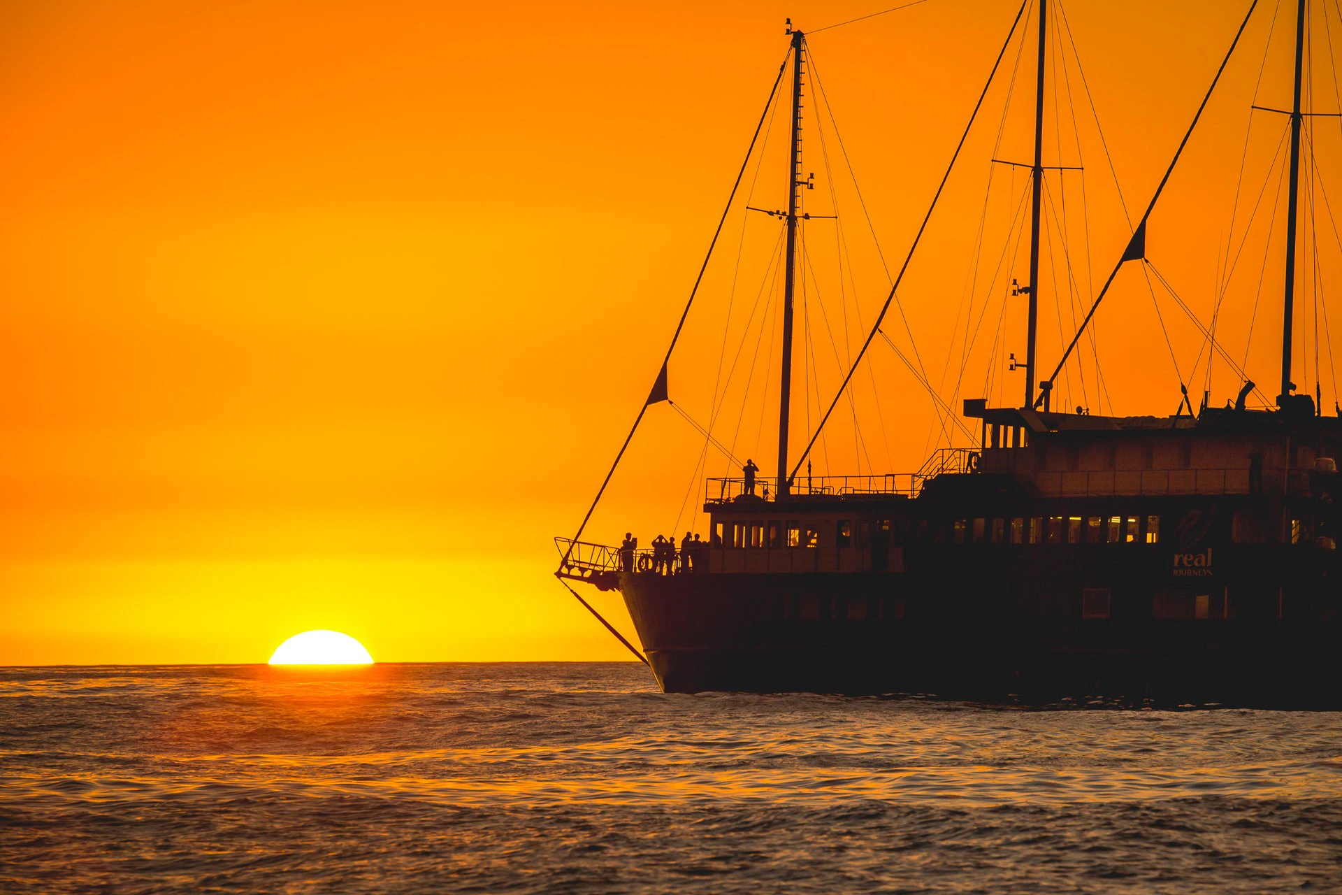 Cruise ship at sunset on Milford Sound overnight tour.