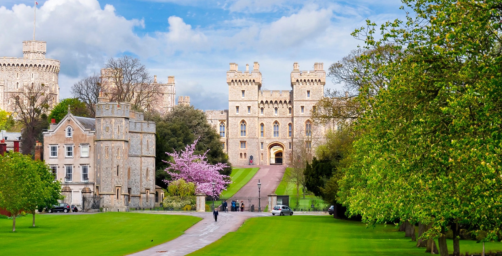 Windsor Castle entrance with lush gardens, part of London to Windsor Castle tours.