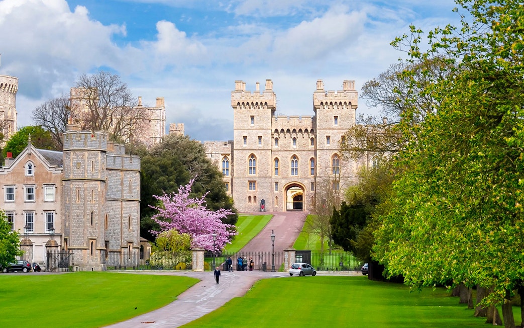 Windsor Castle entrance with lush gardens, part of London to Windsor Castle tours.