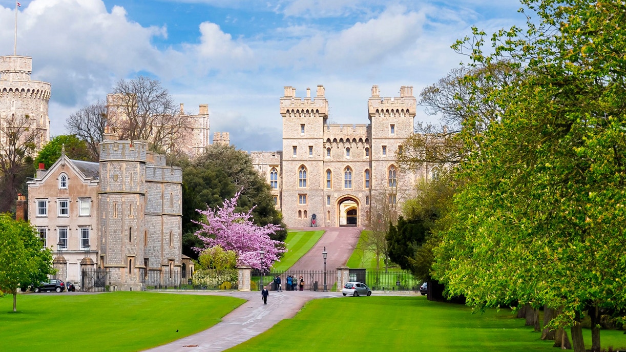 Windsor Castle entrance with lush gardens, part of London to Windsor Castle tours.