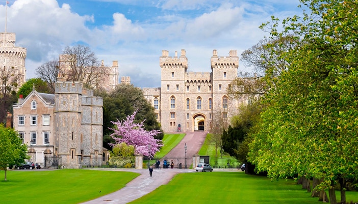 Windsor Castle entrance with lush gardens, part of London to Windsor Castle tours.