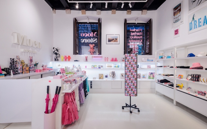 Moco Museum Barcelona gift shop with colorful merchandise and art displays.