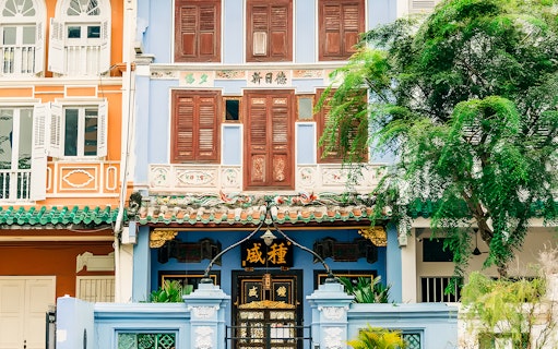 Colorful Peranakan shophouse facade in Singapore on cultural city tour.