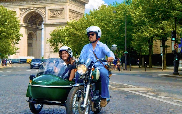 Sidecar tour passing Arc de Triomphe in Paris.