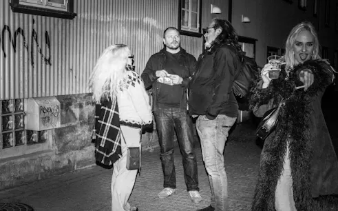 Group discussing outside Reykjavik Punk Museum during guided walking tour on music and youth culture history.