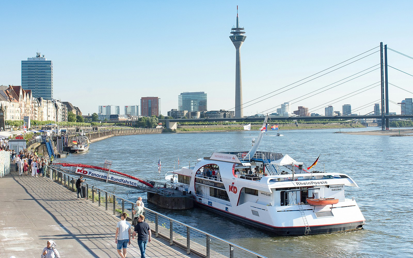 Evening panorama cruise on the Rhine River with cityscape view in Düsseldorf, Germany.