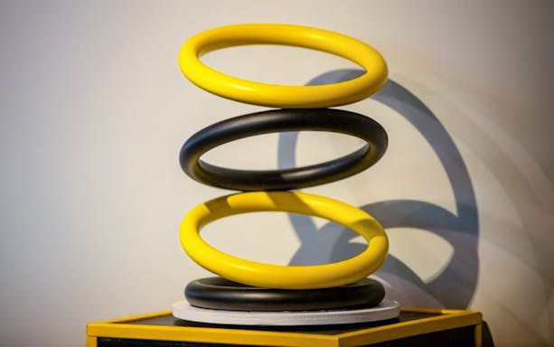 Yellow and black interlocking rings exhibit at Museum of Illusions Genoa.