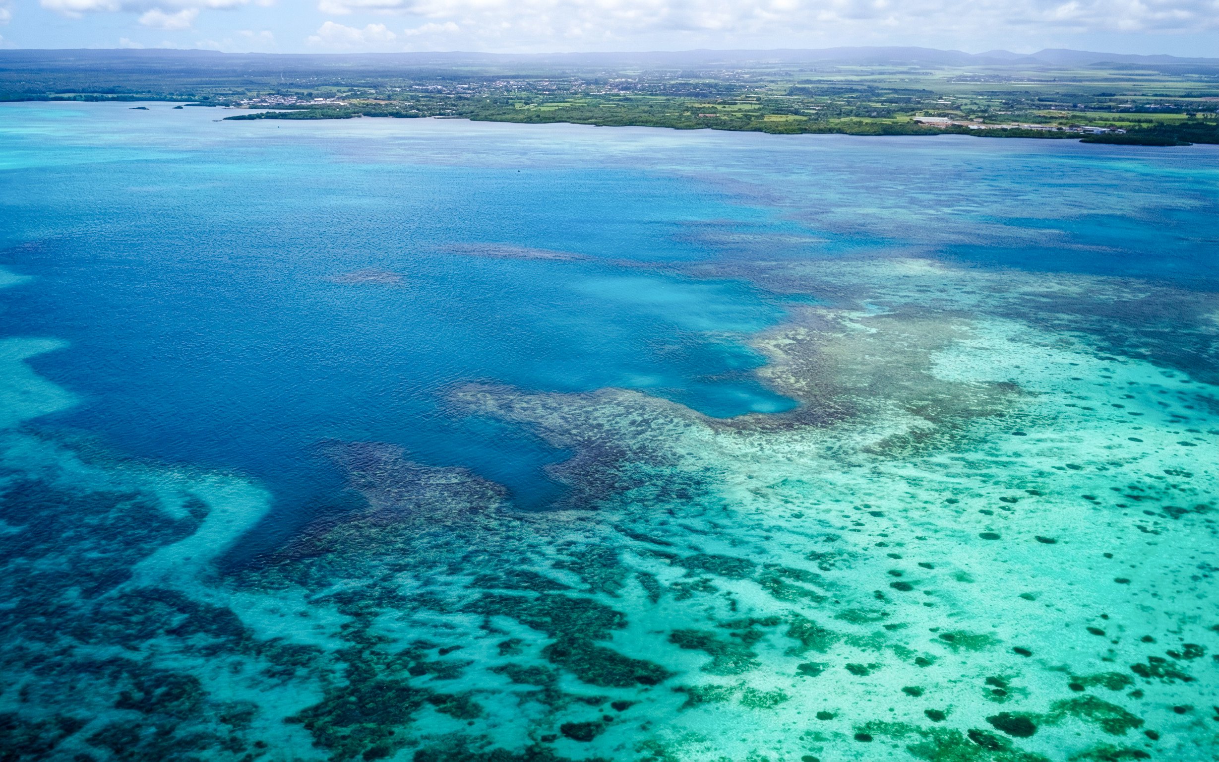 Aerial view of turquoise waters and coastline on the Short Amber Route Seaplane Tour, Mauritius.