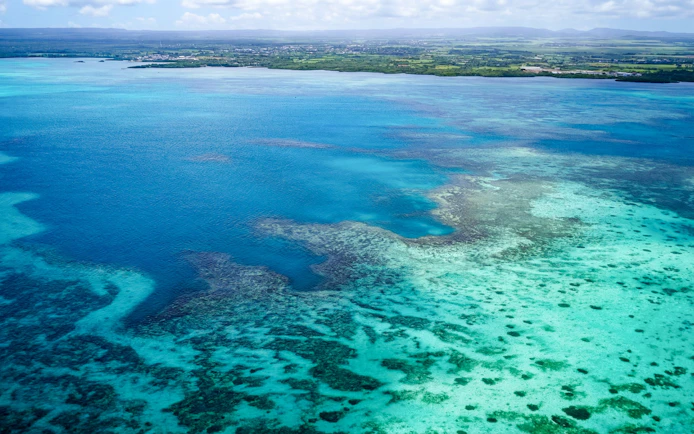 Aerial view of turquoise waters and coastline on the Short Amber Route Seaplane Tour, Mauritius.