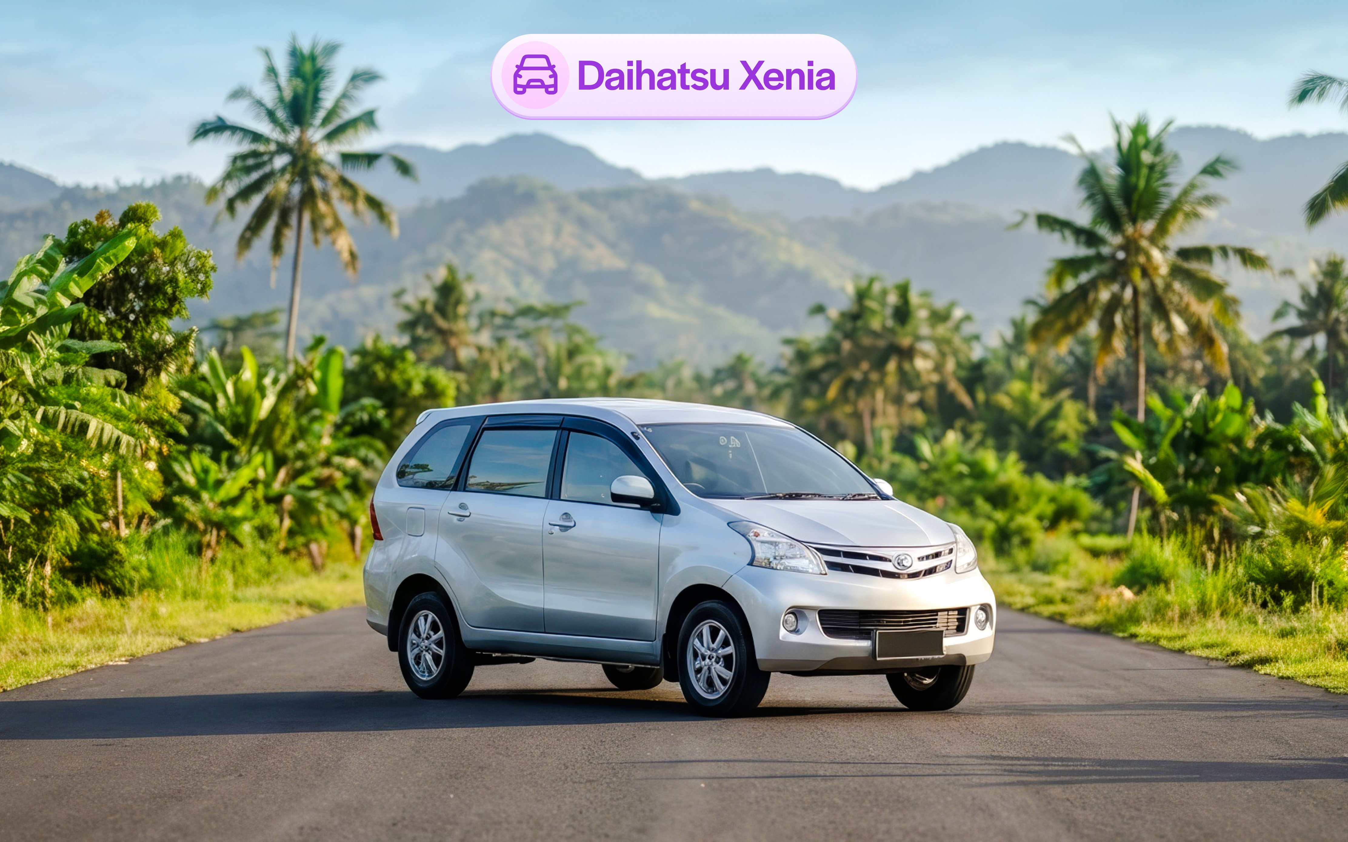 Daihatsu Xenia parked on a scenic road in Bali with palm trees and mountains.