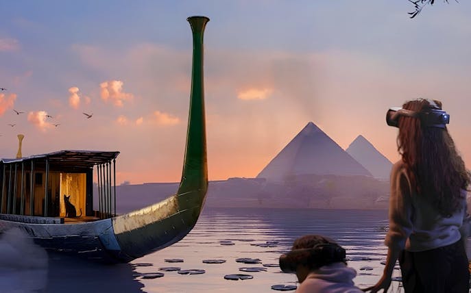 Guests using VR to explore ancient Egyptian boat near pyramids at sunset.