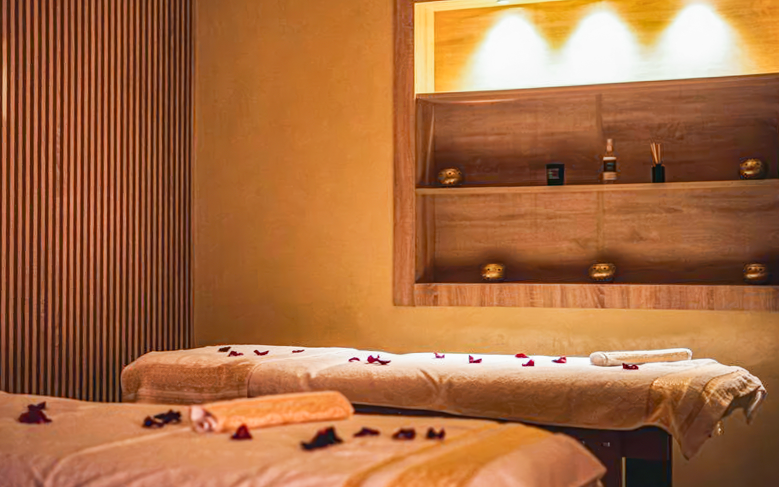 Spa treatment room with massage tables and rose petals, part of Traditional Treatment Hammam & Spa.