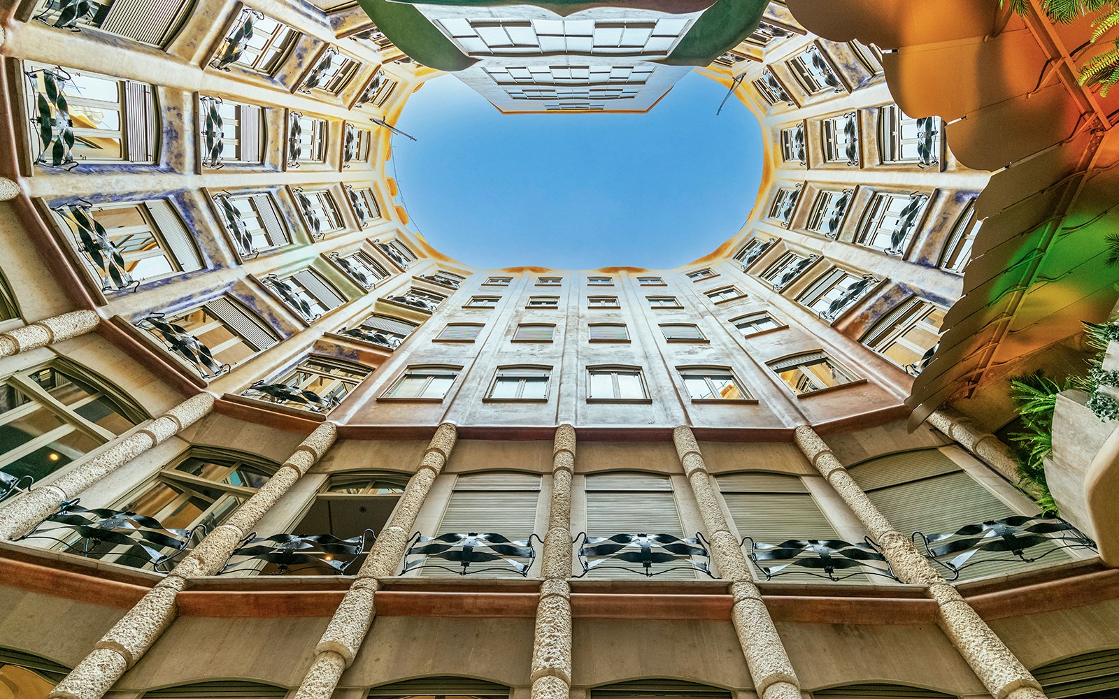 Courtyard view of La Pedrera-Casa Milà in Barcelona, showcasing unique architecture.