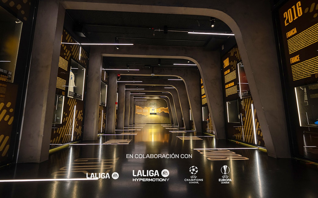 Interiors of the Home of Football Museum in Madrid with illuminated displays and exhibits.