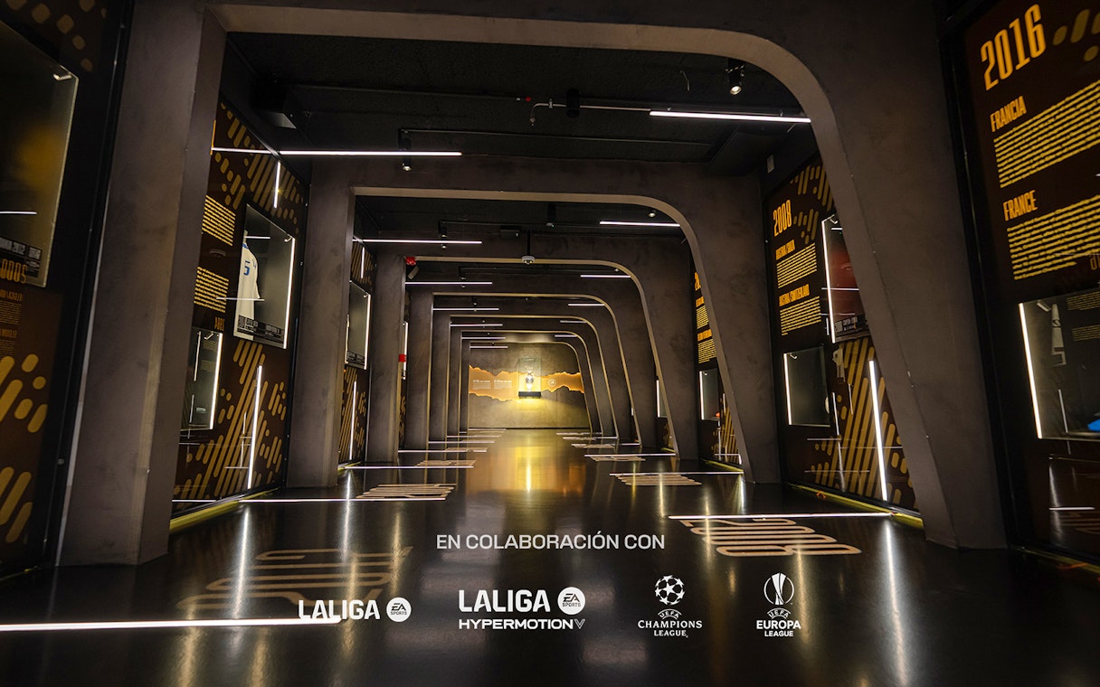 Interiors of the Home of Football Museum in Madrid with illuminated displays and exhibits.
