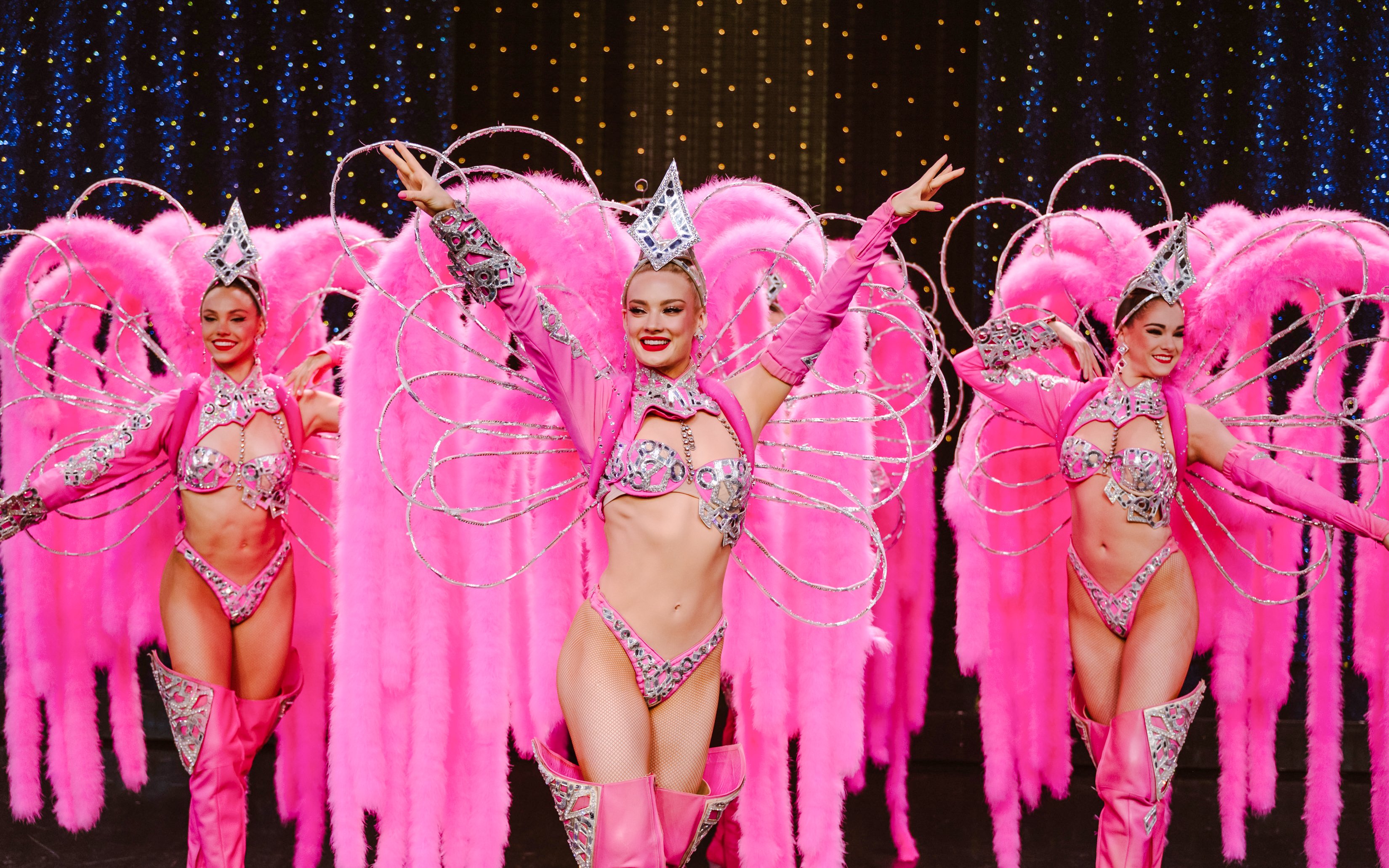 Performers in pink feather costumes at Moulin Rouge Show, Paris.