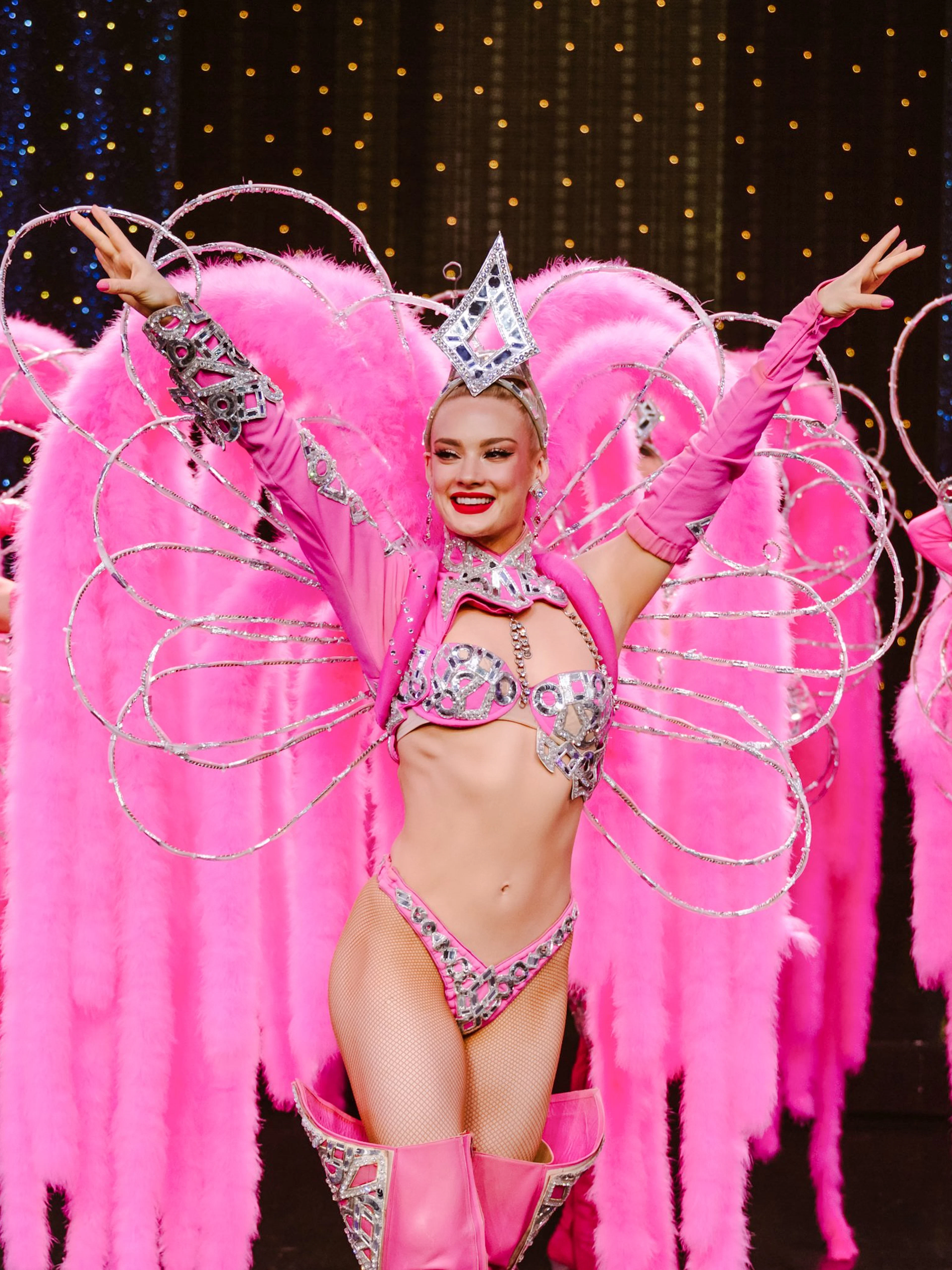 Performers in pink feather costumes at Moulin Rouge Show, Paris.