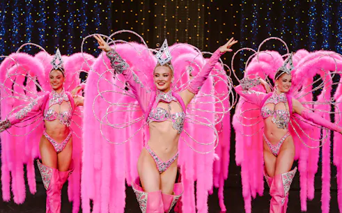 Performers in pink feather costumes at Moulin Rouge Show, Paris.
