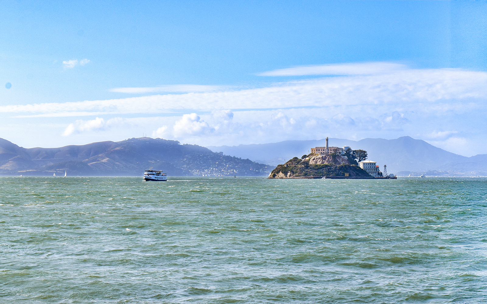 Ferry departing Alcatraz Island, San Francisco Bay, with distant hills.
