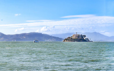 Ferry departing Alcatraz Island, San Francisco Bay, with distant hills.