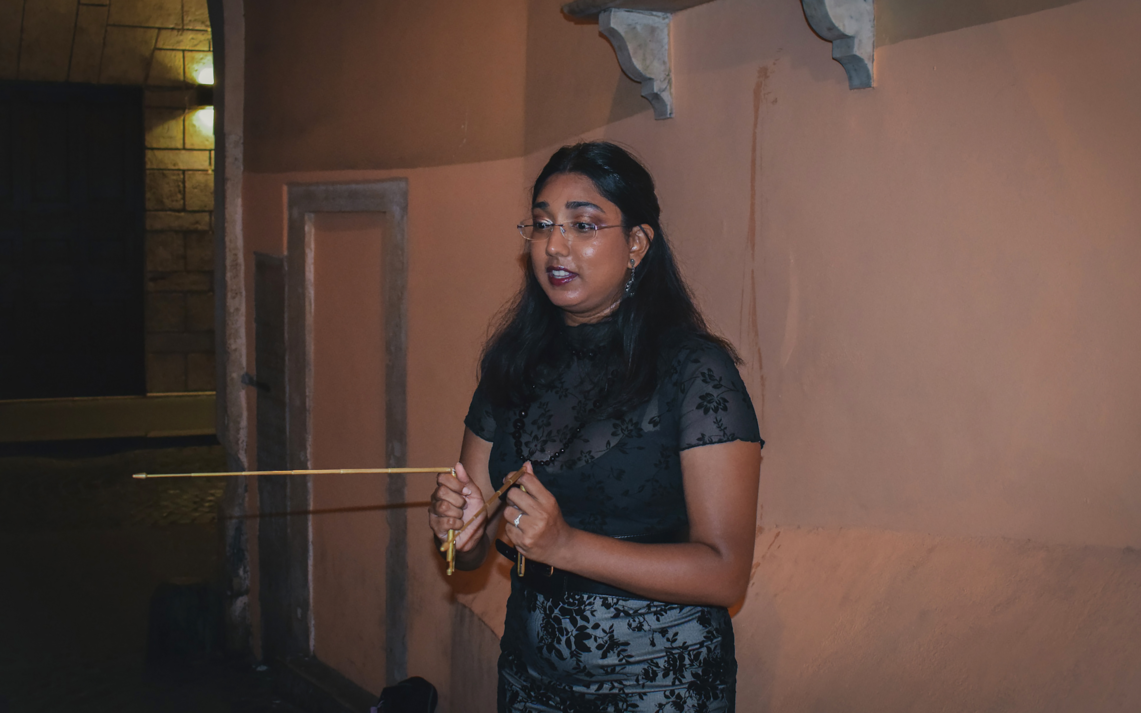 Tour guide leading a ghost walking tour in Rome at night.