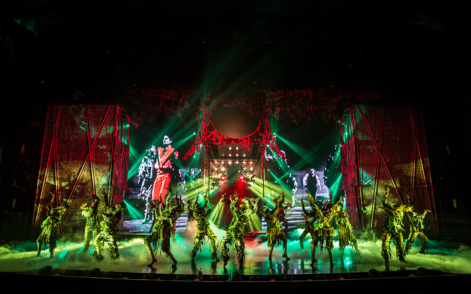 Performers on stage at Michael Jackson ONE show with vibrant lights and costumes.