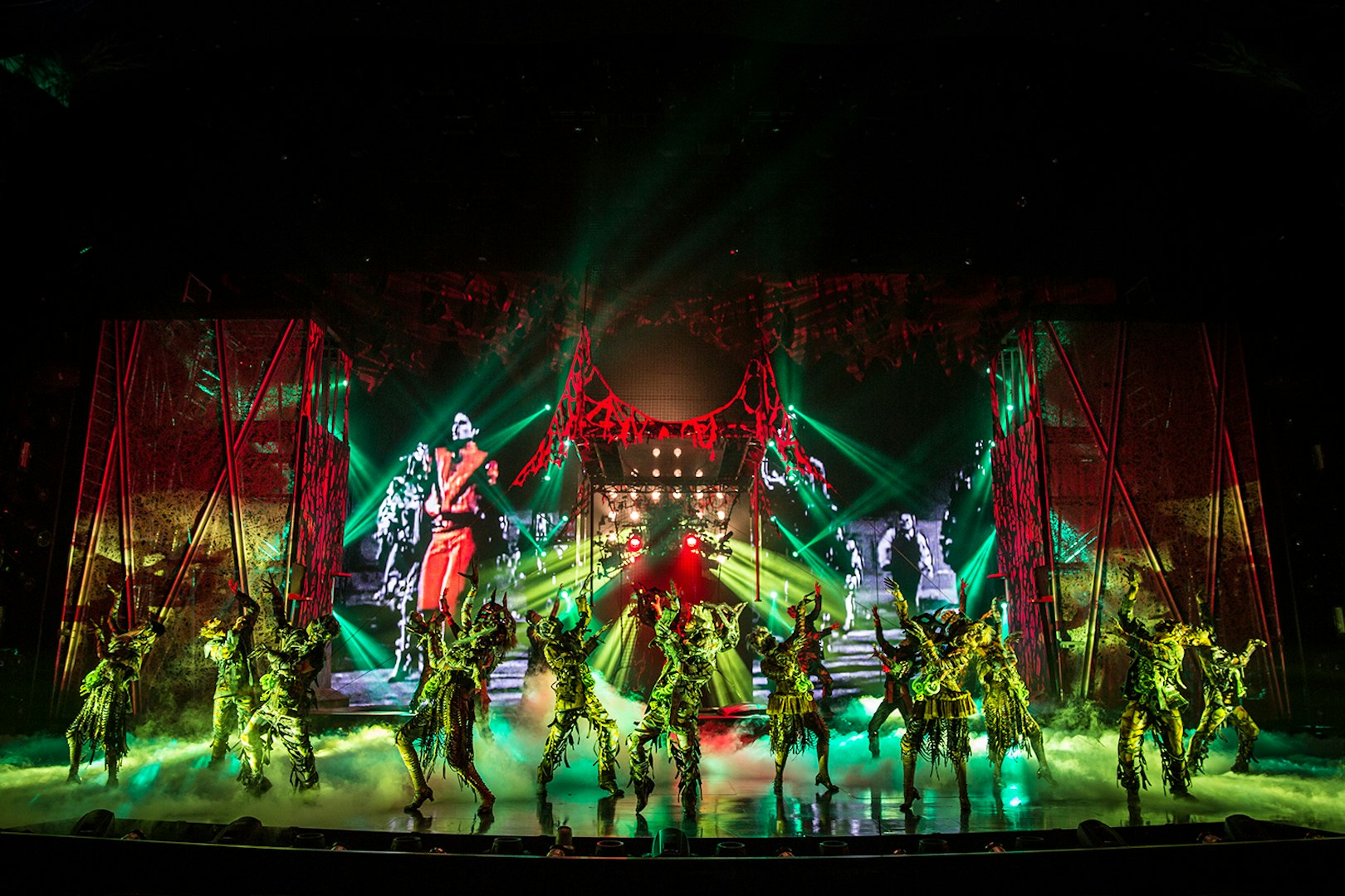 Performers on stage at Michael Jackson ONE show with vibrant lights and costumes.